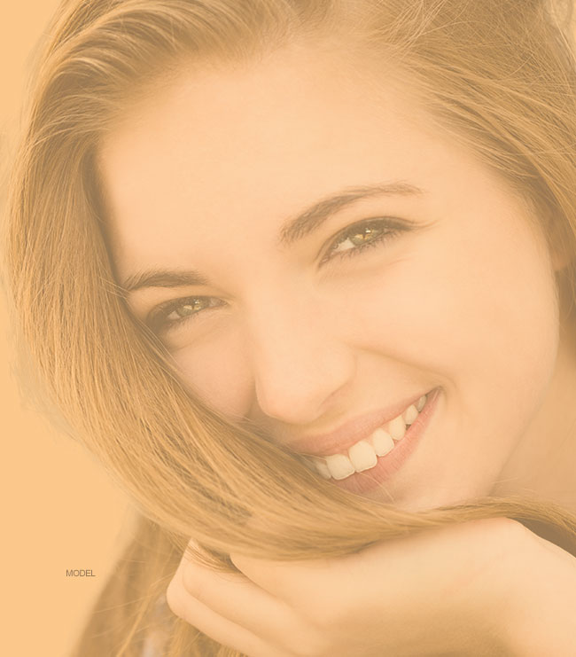 Woman touching her hair smiling