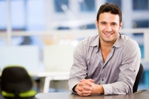 Man in a button up sitting at a table