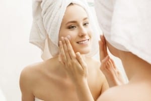 Woman Moisturizing Face