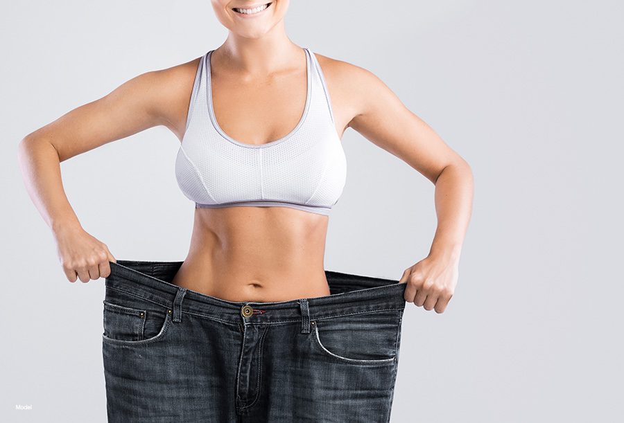 Woman standing inside really large pants